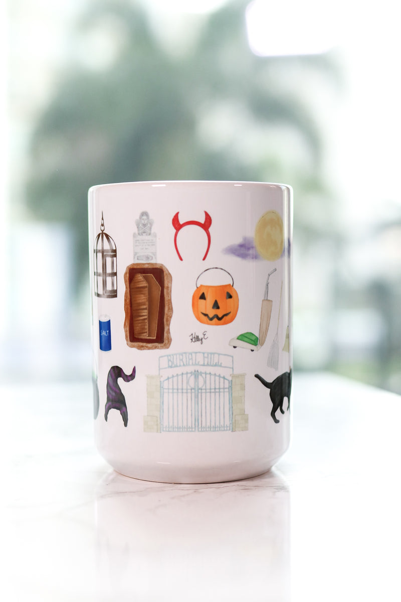 Hocus Pocus mug. The infamous spell book, the Sanderson Sisters' hairstyles, the cauldron, Old Burial Hill cemetery, Billy Butcherson's headstone, the vacuum, broom, and mop, the black flame candle, Dani's witch hat, Binx the black cat, the Sanderson house