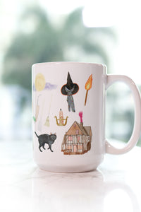 Hocus Pocus mug. The infamous spell book, the Sanderson Sisters' hairstyles, the cauldron, Old Burial Hill cemetery, Billy Butcherson's headstone, the vacuum, broom, and mop, the black flame candle, Dani's witch hat, Binx the black cat, the Sanderson house