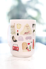 The Holiday movie Christmas mug. Iris's cottage in Surrey, Amanda's house in LA, hot chocolate with five marshmallows, the girls' tent, Frappuccinos with a little dollop and big dollop, a night with Arthur invitation and his tie, Arthur's Oscar, Arthur's orchid corsage for Iris, Amanda's sleep mask, Miles's keyboard, Iris's Mini Cooper, Berry Kiss lipstick, and more!