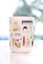 The Holiday movie Christmas mug. Iris's cottage in Surrey, Amanda's house in LA, hot chocolate with five marshmallows, the girls' tent, Frappuccinos with a little dollop and big dollop, a night with Arthur invitation and his tie, Arthur's Oscar, Arthur's orchid corsage for Iris, Amanda's sleep mask, Miles's keyboard, Iris's Mini Cooper, Berry Kiss lipstick, and more!